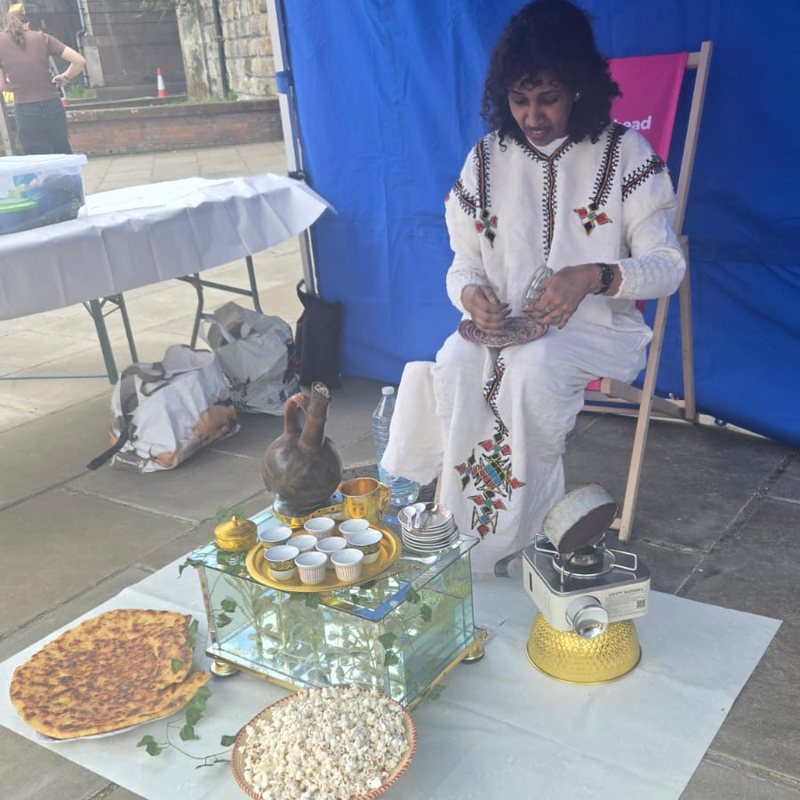 A TWECA member preparing a traditional coffee ceremony at a community event in Gateshead