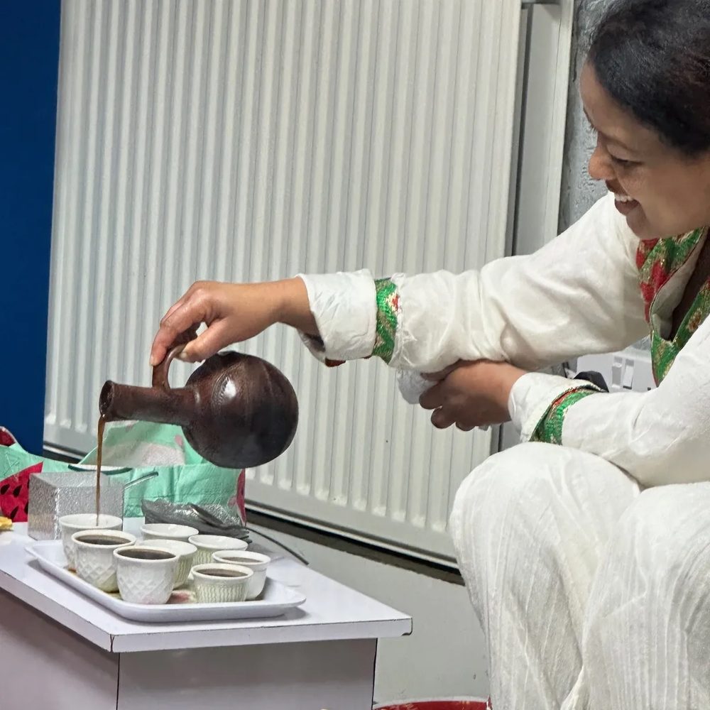 Pouring coffee at an Eritrean coffee ceremony